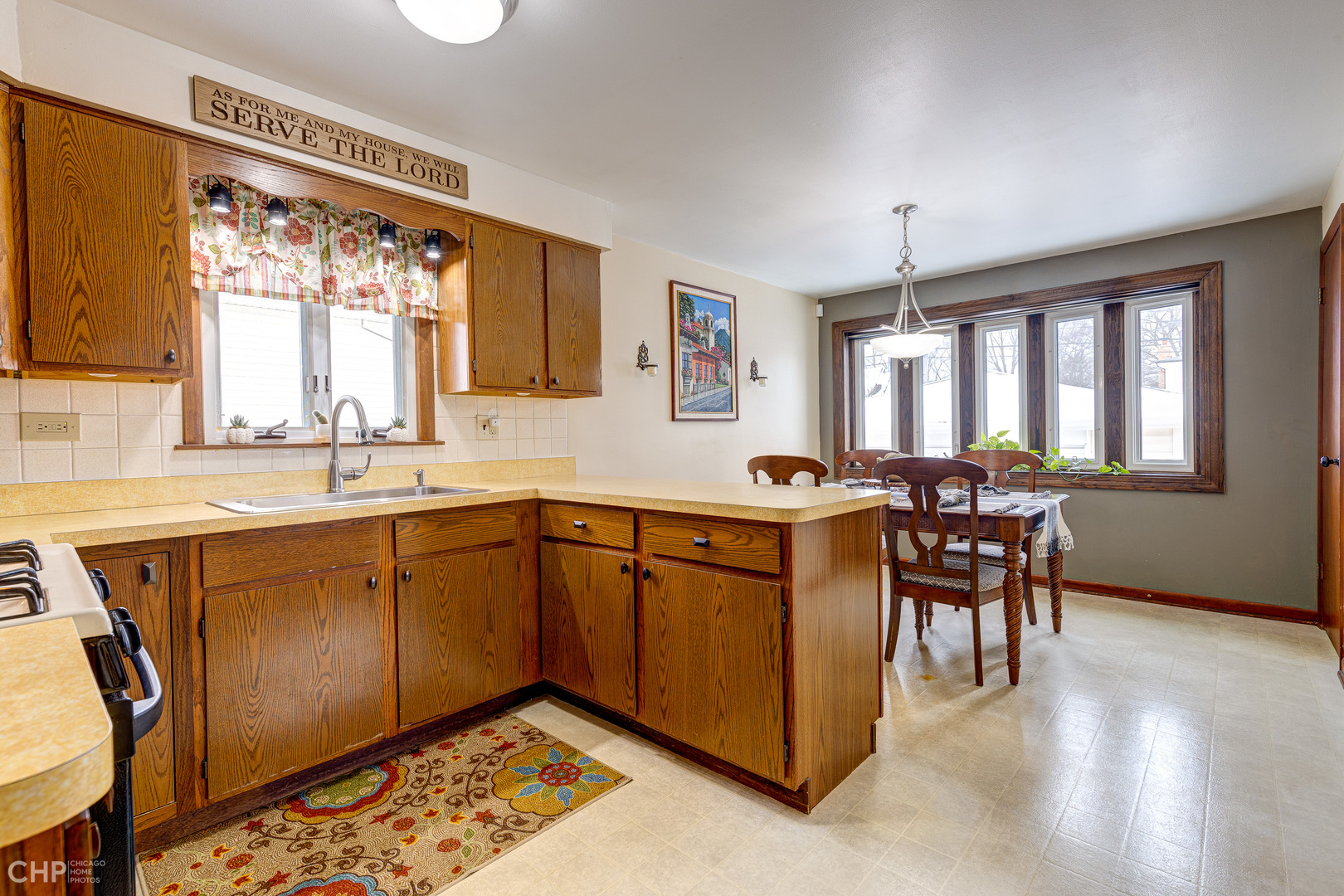 10808 Massasoit Avenue Chicago Ridge, IL 60415 - Photo 13 of 33 a kitchen with stainless steel appliances granite countertop sink window and dining table