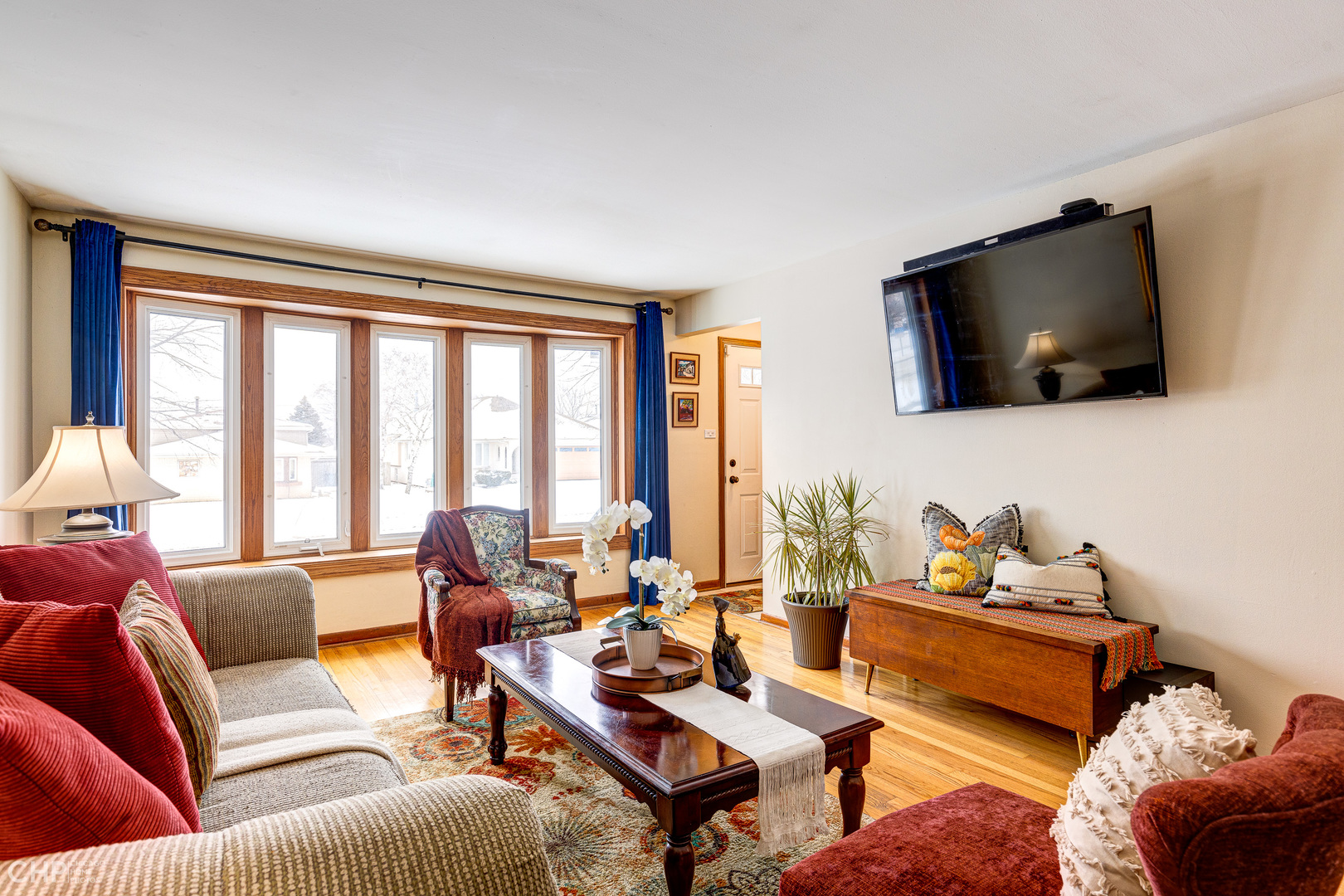 10808 Massasoit Avenue Chicago Ridge, IL 60415 - Photo 7 of 33 a living room with furniture a flat screen tv and a floor to ceiling window