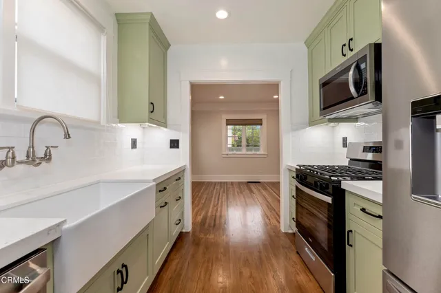 a kitchen with a stove microwave and refrigerator