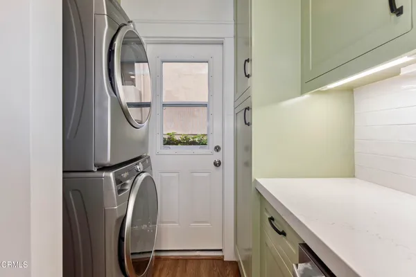 a spacious kitchen with stainless steel appliances a sink stove and refrigerator