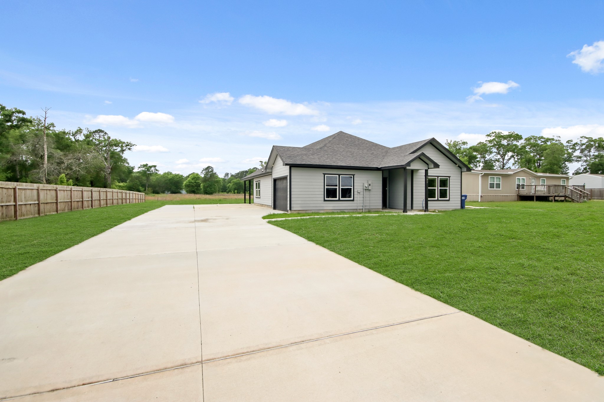 131 South Tyler Road Goodrich, TX 77335 - Photo 24 of 26 a view of a house with a yard and potted plants