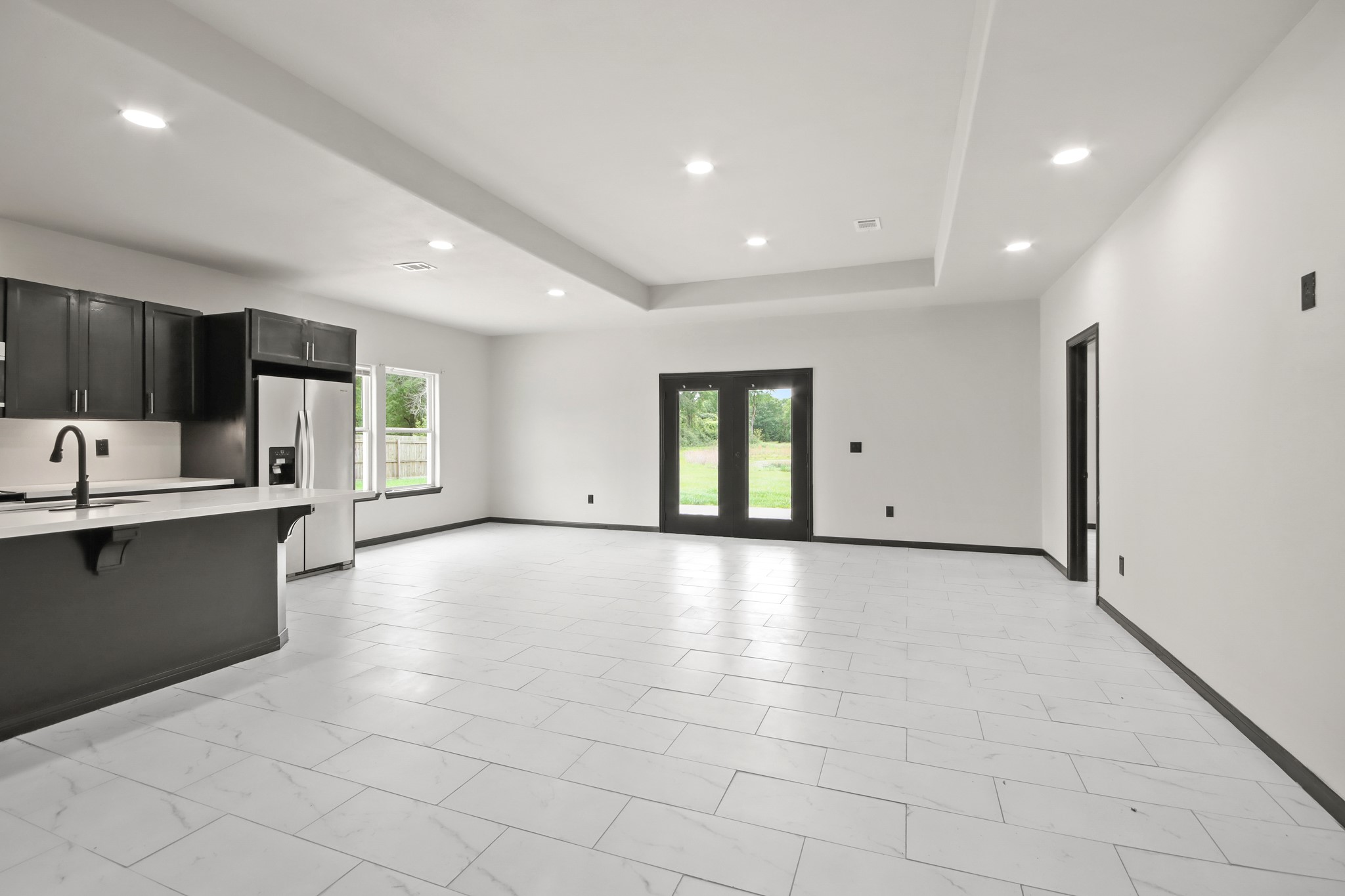 131 South Tyler Road Goodrich, TX 77335 - Photo 4 of 26 a view of an empty room with kitchen and window
