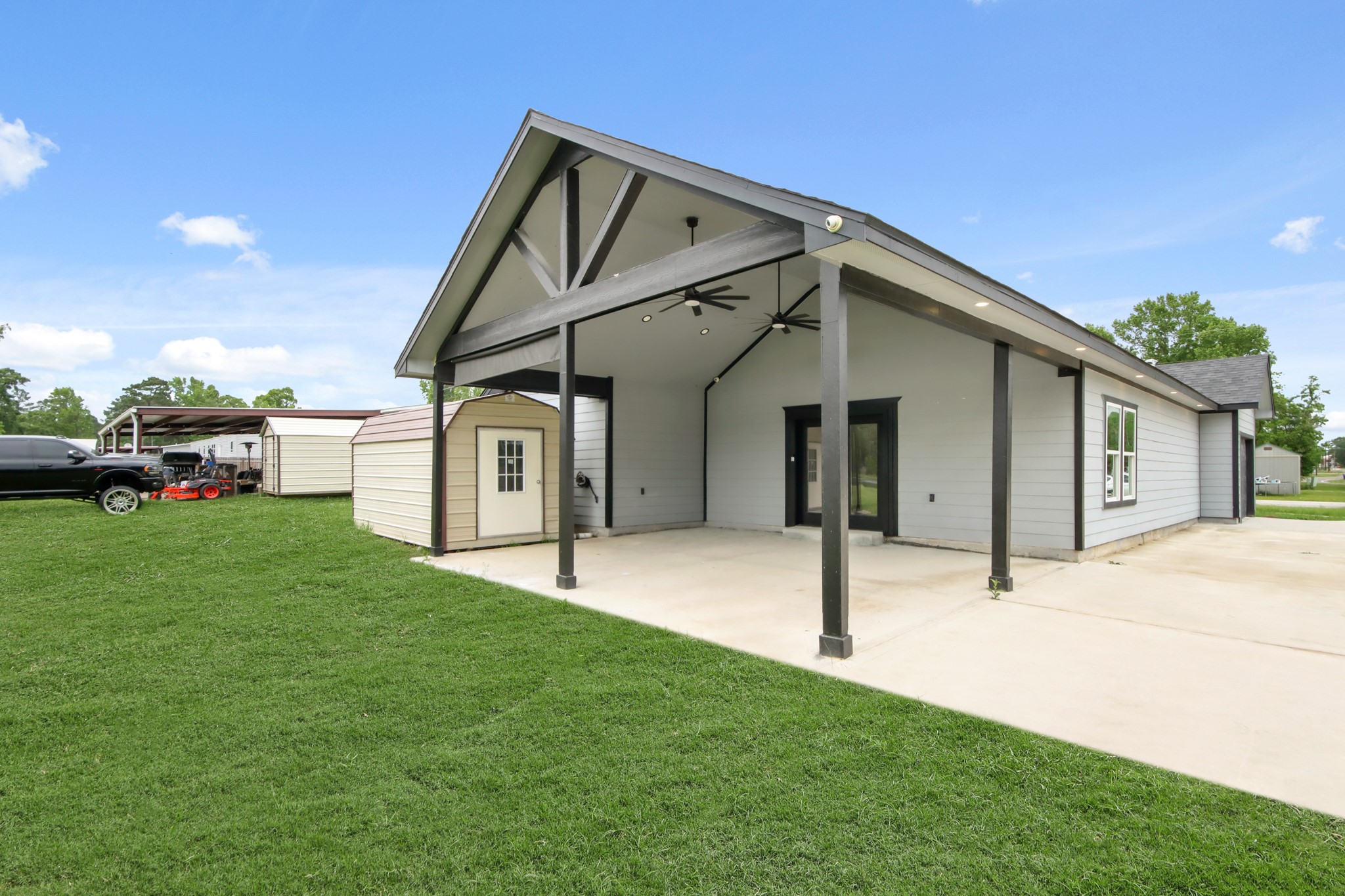 131 South Tyler Road Goodrich, TX 77335 - Photo 5 of 26 a front view of a house with a garden and yard