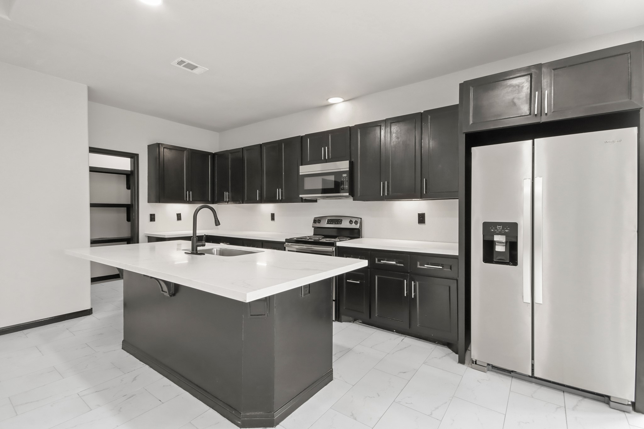 131 South Tyler Road Goodrich, TX 77335 - Photo 7 of 26 a kitchen with stainless steel appliances granite countertop a sink stove refrigerator and cabinets