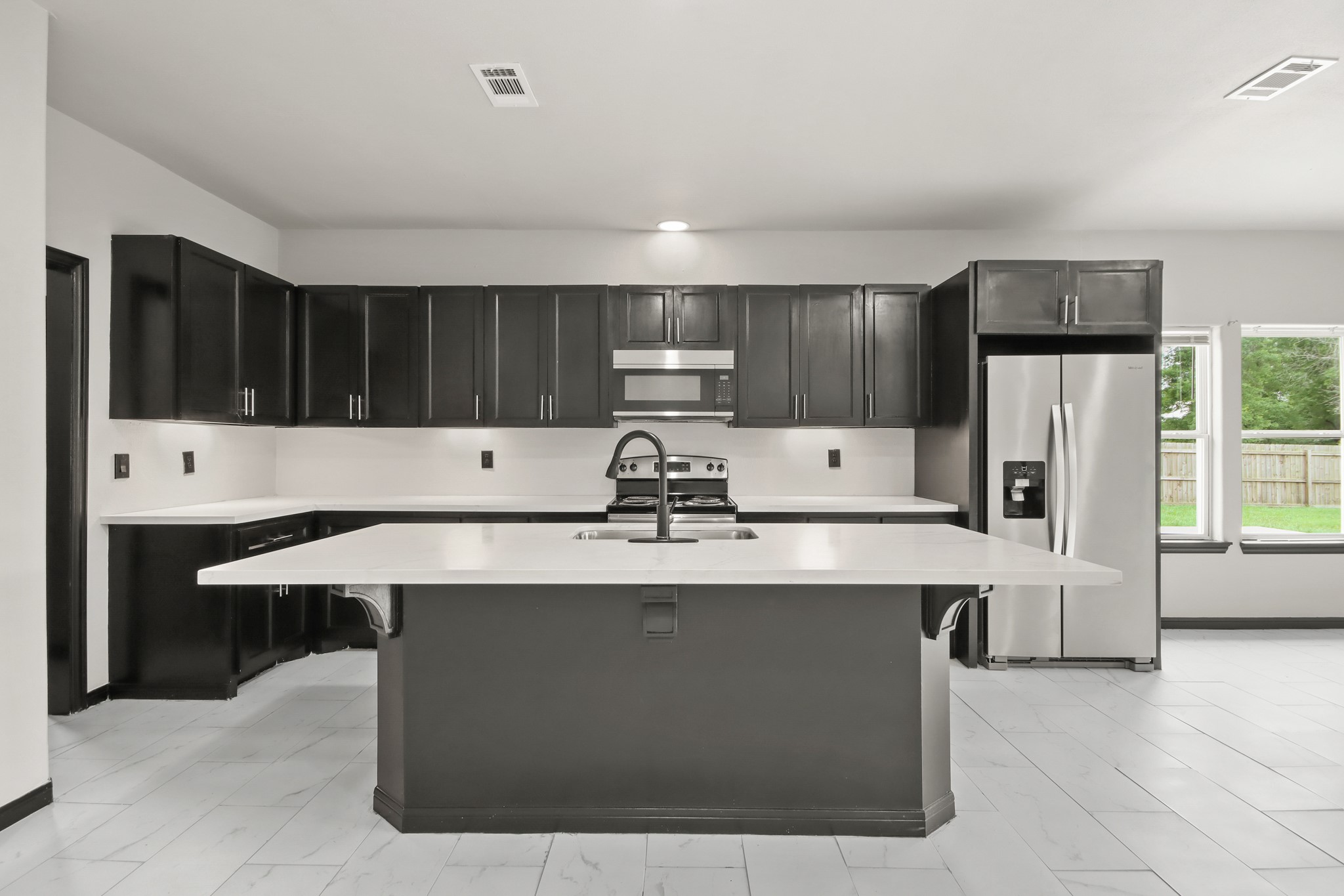 131 South Tyler Road Goodrich, TX 77335 - Photo 8 of 26 a kitchen with stainless steel appliances kitchen island a cabinets and a counter top space