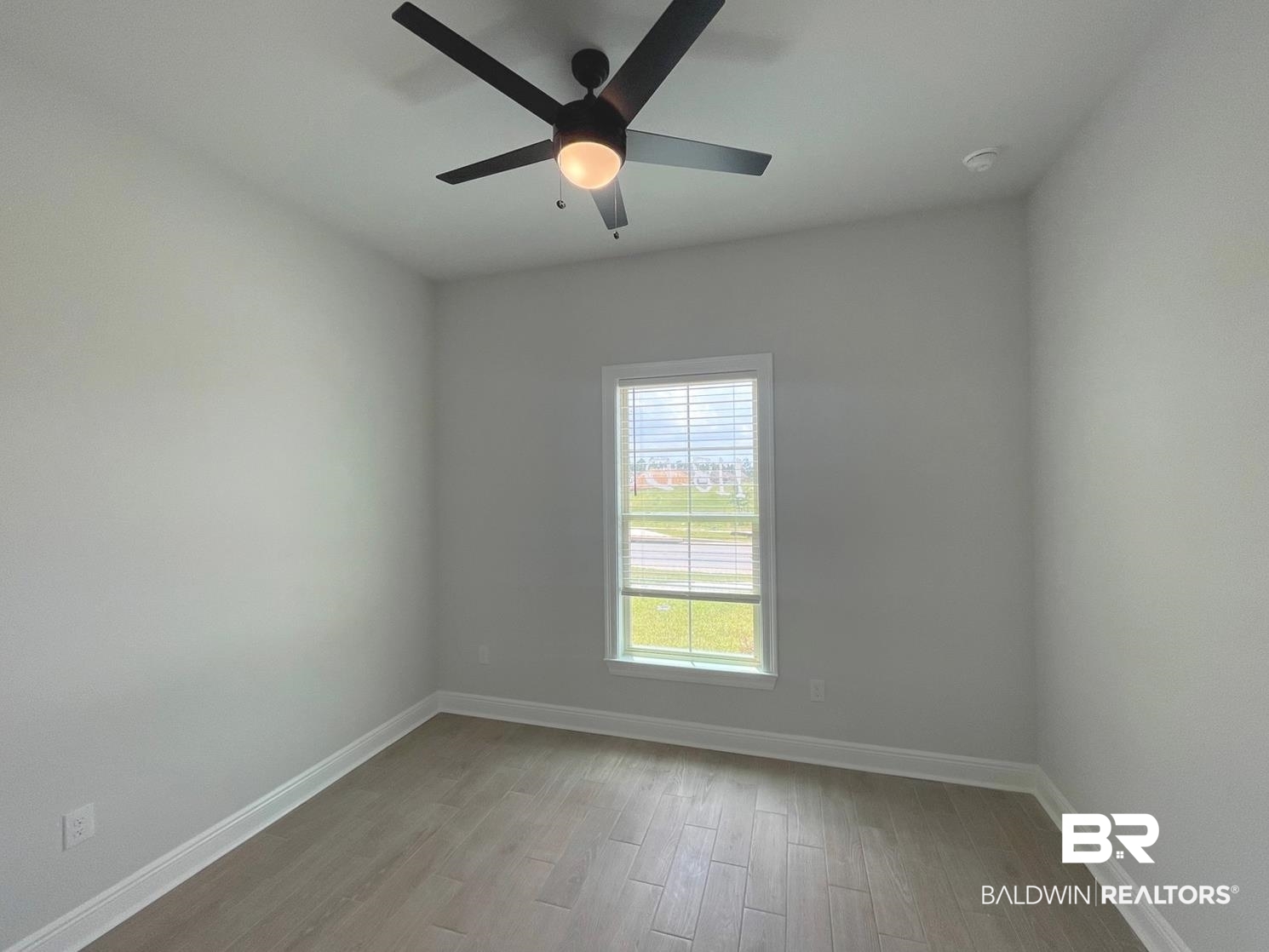 1642 Fenton Circle Foley, AL 36535 - Photo 9 of 14 Unfurnished room with ceiling fan and light wood-type flooring