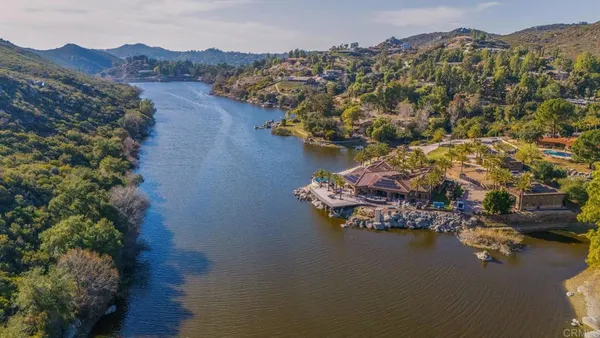 a view of a livingroom with furniture and a floor to ceiling window