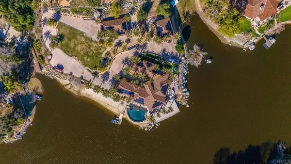 a kitchen with stainless steel appliances kitchen island granite countertop a table chairs sink and cabinets