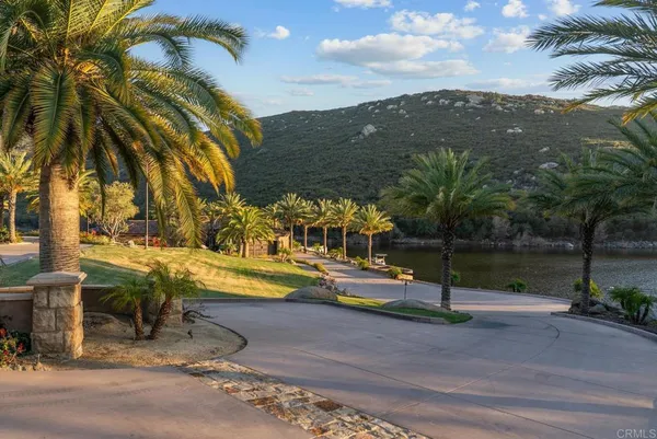 a dining room with furniture wooden floor a rug and a painting