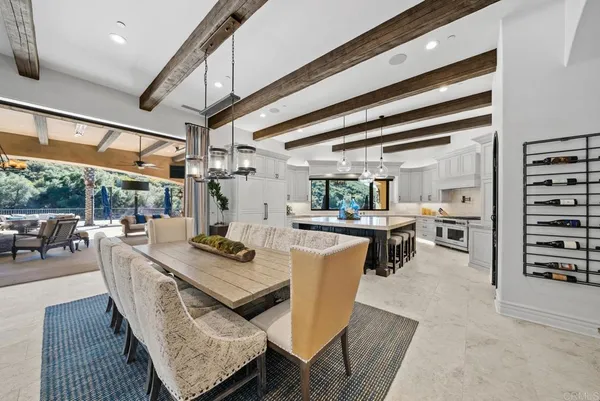 a living room with patio furniture and a wooden floor