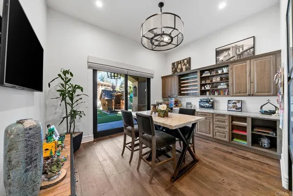 a bathroom with a granite countertop sink a mirror and shower