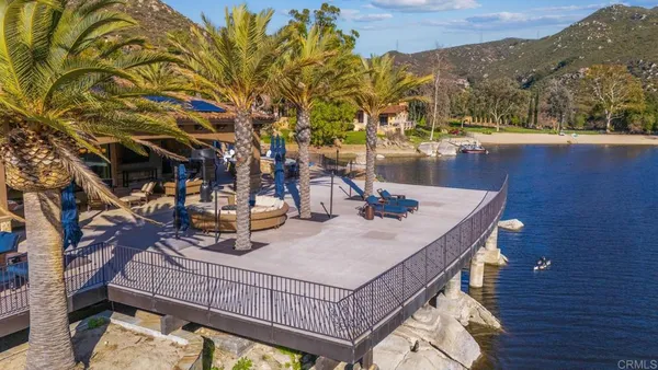 a living room with patio furniture and a large window