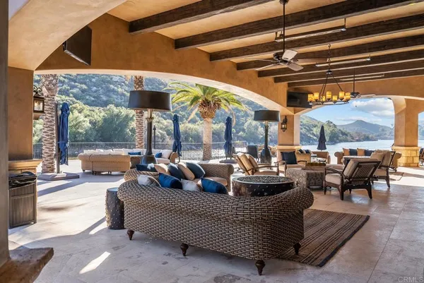 a view of a house with swimming pool and sitting area