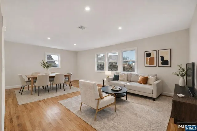 a living room with furniture dining table and a large window