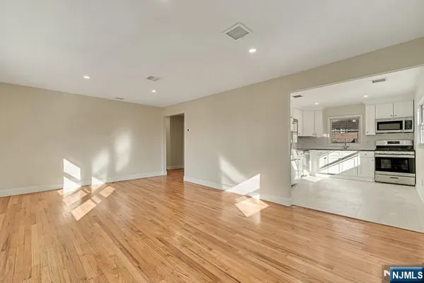 a view of a kitchen with wooden floor