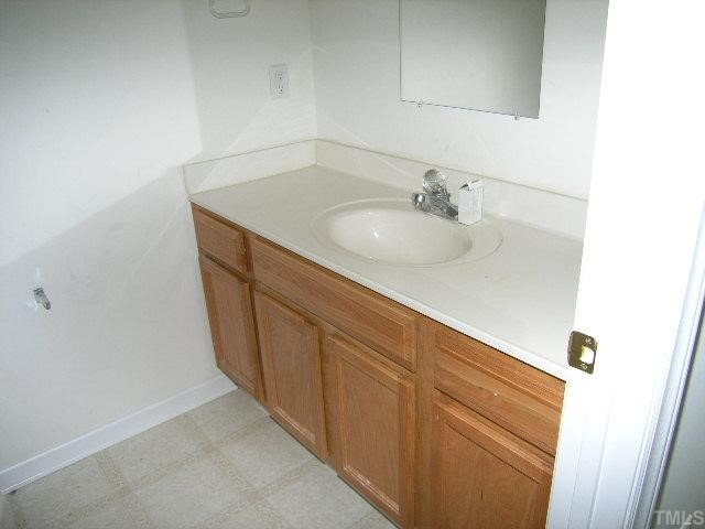 5328 Fayetteville Road Durham, NC 27713 - Photo 3 of 5 a bathroom with a sink and a mirror