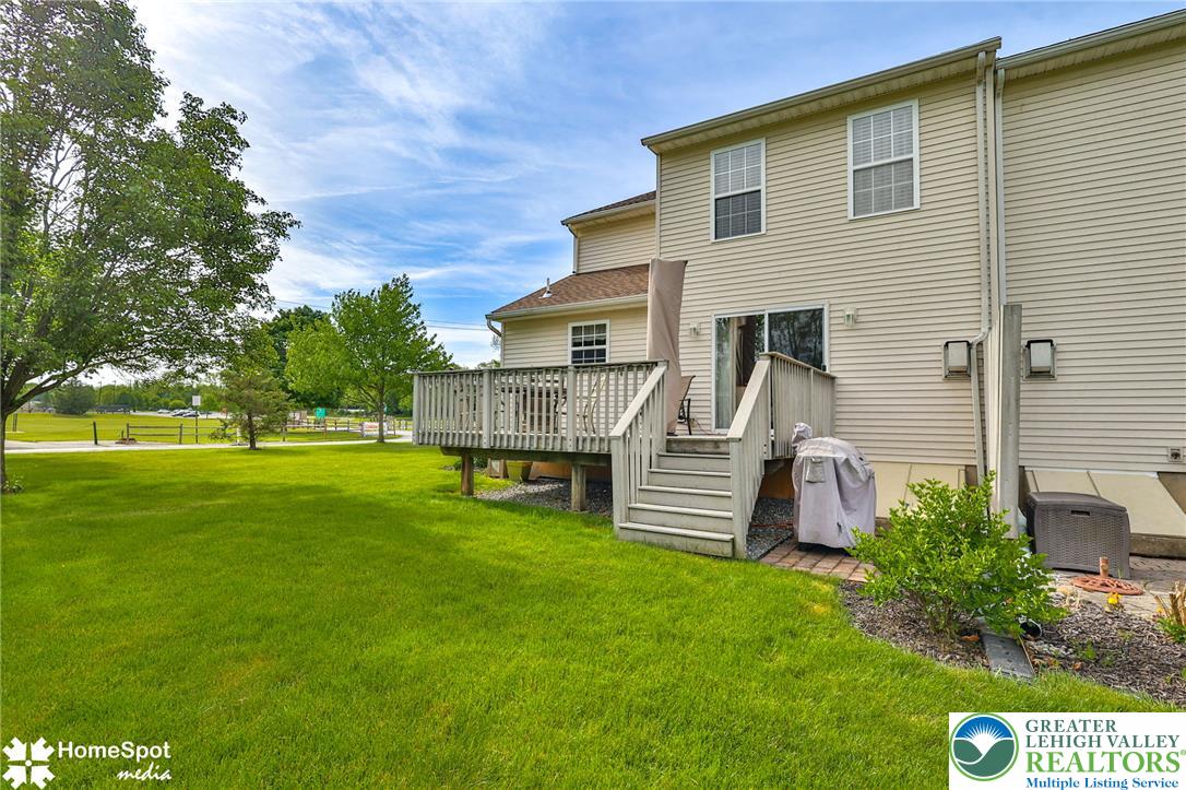 4191 Walter Road Bethlehem, PA 18020 - Photo 21 of 23 A spacious wooden deck provides ample outdoor living space, overlooking a lush green yard.