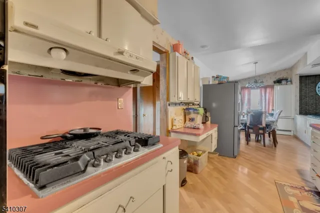 a kitchen with a stove and a refrigerator