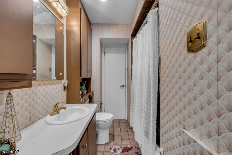 693 Hemlock Street Rahway, NJ 07065 - Photo 18 of 29 a bathroom with a sink and mirror with toilet