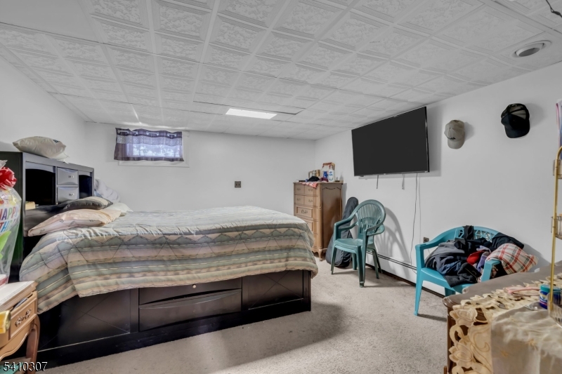 693 Hemlock Street Rahway, NJ 07065 - Photo 26 of 29 a bedroom with a bed and a flat screen tv