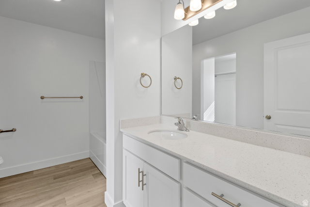 1271 West 500 South Logan, UT 84321 - Photo 14 of 26 Bathroom featuring a single vanity with a white countertop and undermount sink, brushed nickel faucet, and white cabinetry with brushed nickel hardware