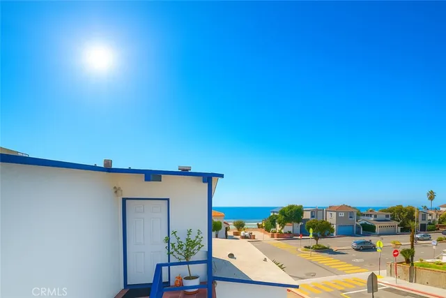 a view of a swimming pool with an outdoor seating and a balcony