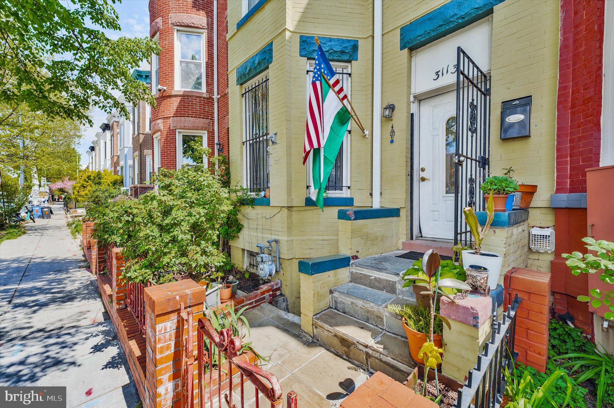 3113 11th Street Northwest Washington, DC 20010 - Photo 3 of 42 Charming entrance with vibrant flags.