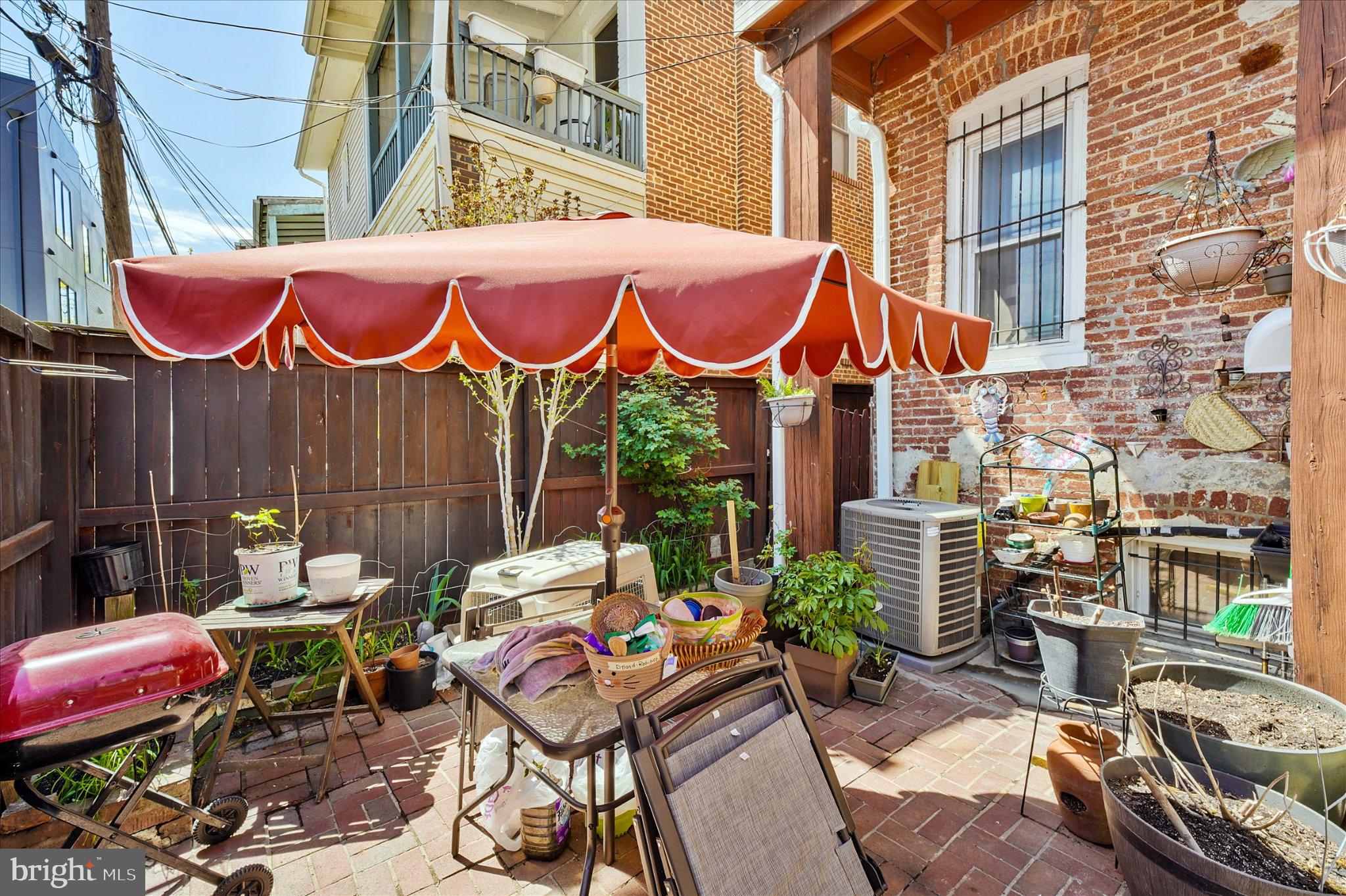3113 11th Street Northwest Washington, DC 20010 - Photo 36 of 42 Charming patio with vibrant umbrella.
