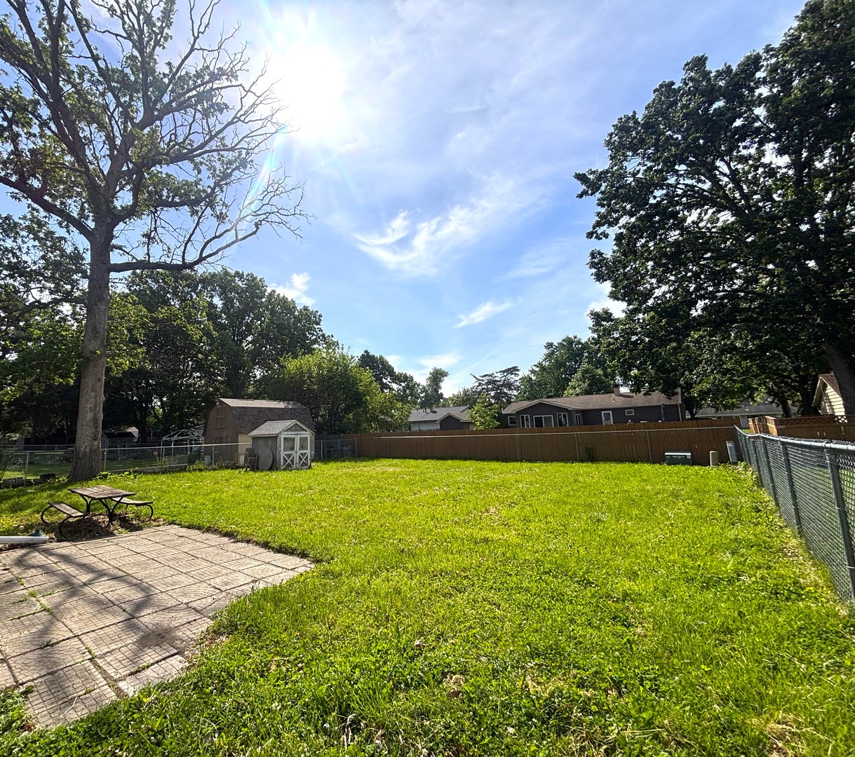 22 Guilford Road Montgomery, IL 60538 - Photo 14 of 14 a view of outdoor space with swimming pool and trees