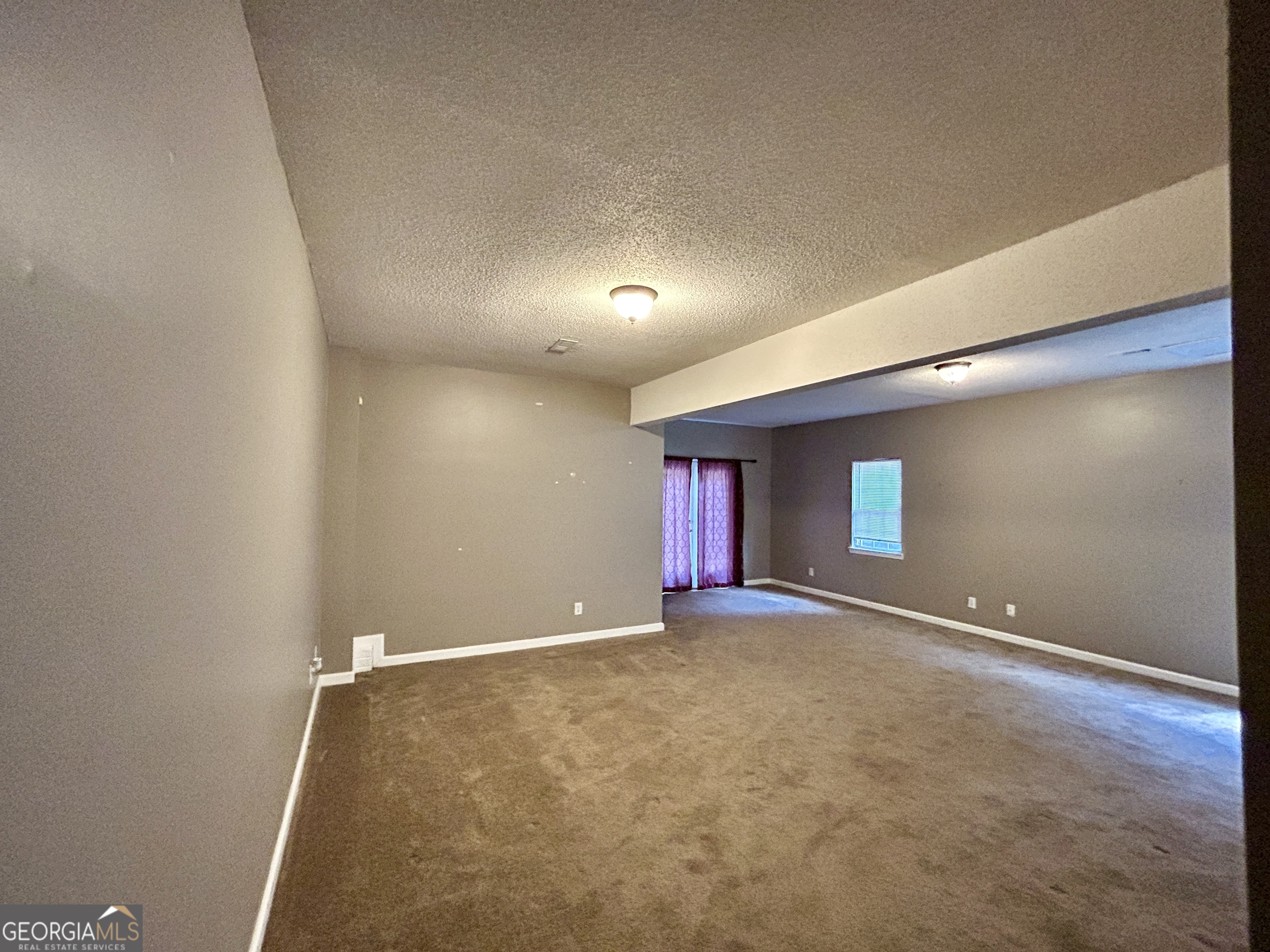 98 Pheasant Ridge Newnan, GA 30265 - Photo 15 of 23 a view of an empty room with window and stairs