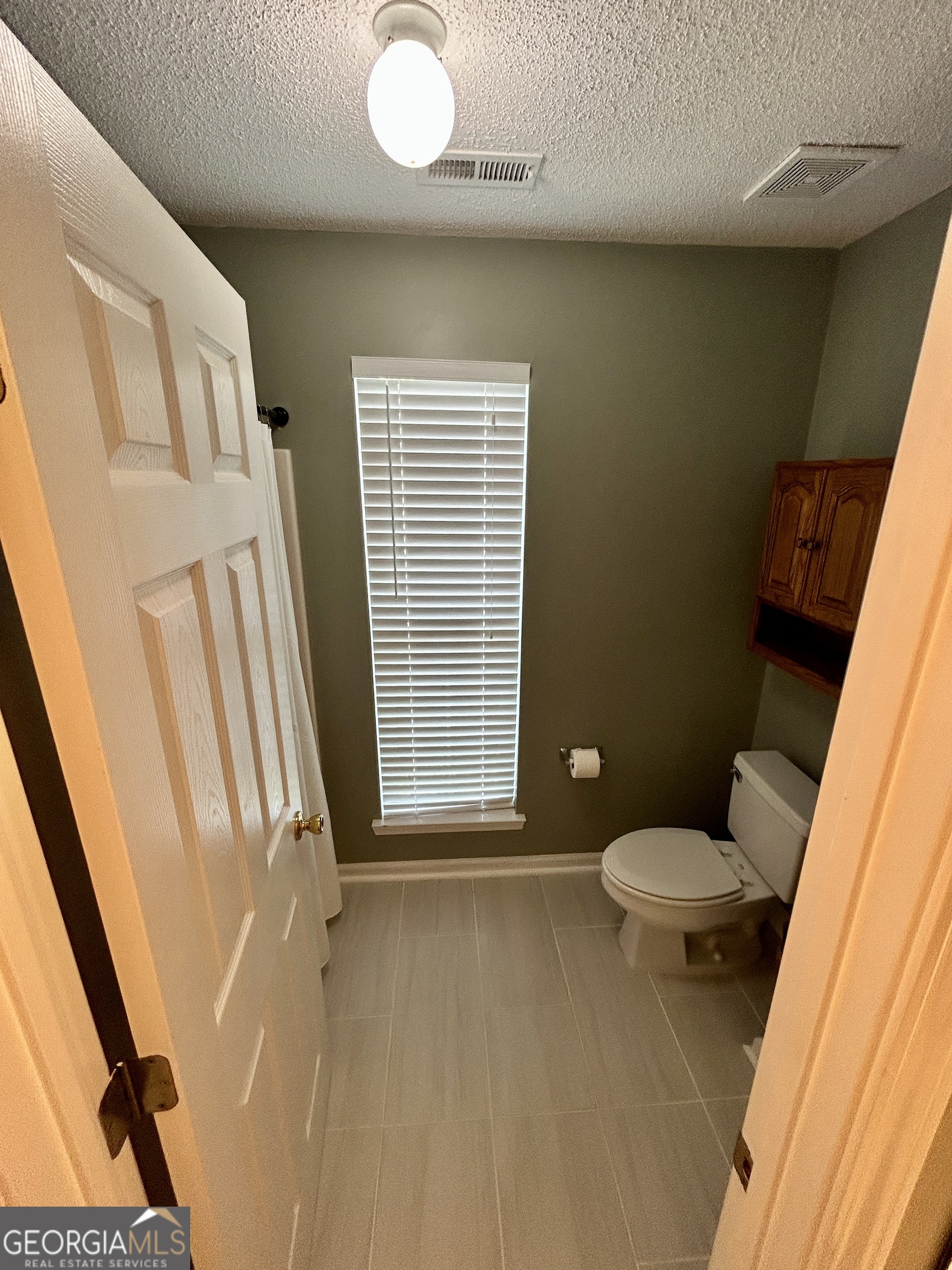 98 Pheasant Ridge Newnan, GA 30265 - Photo 18 of 23 a bathroom with a toilet and a shower