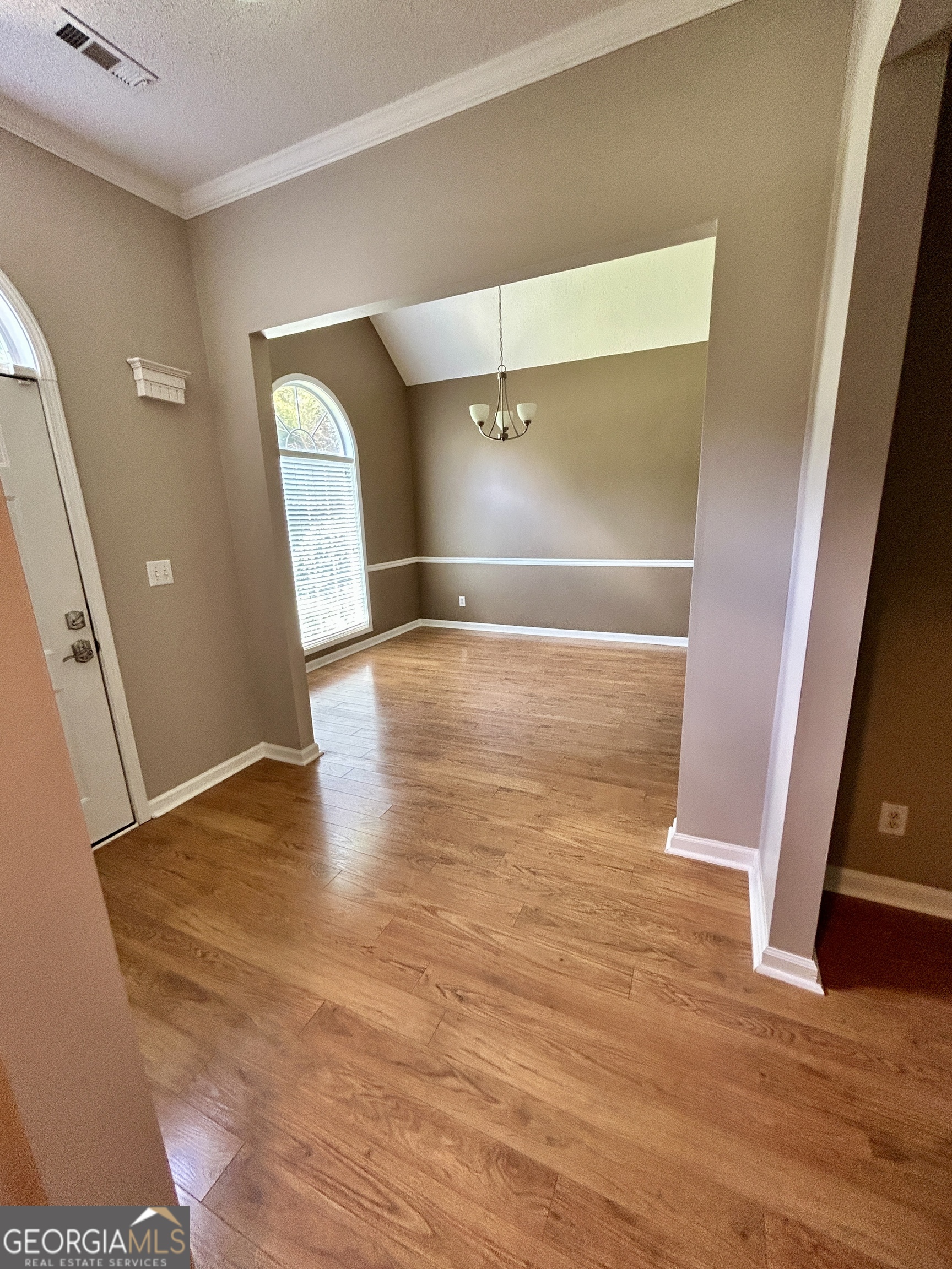 98 Pheasant Ridge Newnan, GA 30265 - Photo 2 of 23 a view of an empty room with wooden floor and a window