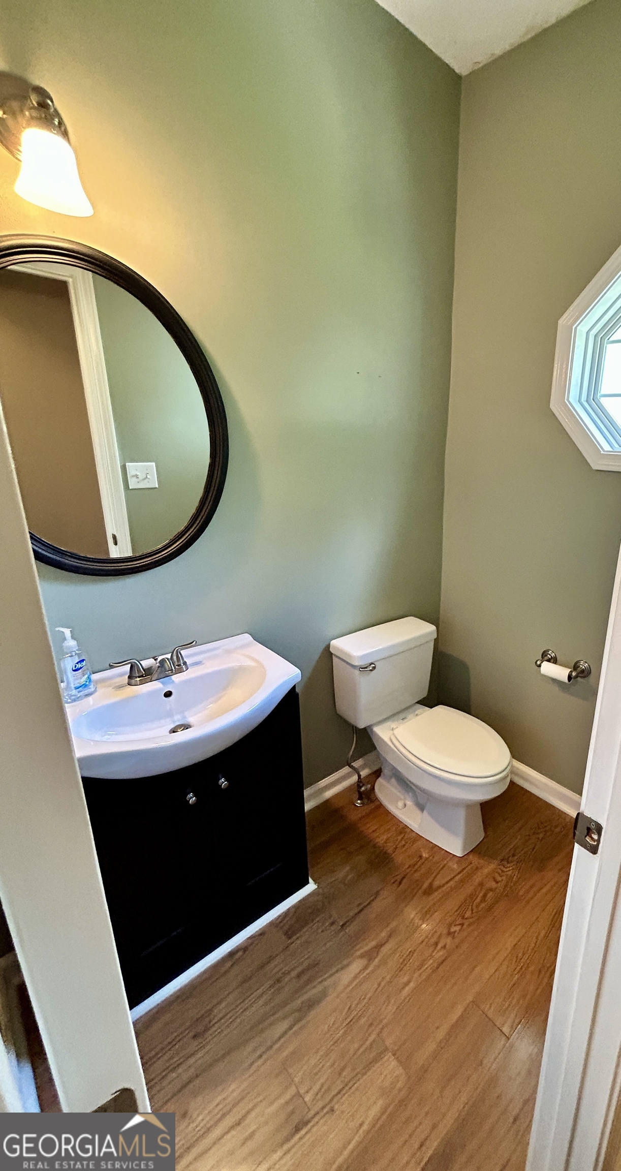 98 Pheasant Ridge Newnan, GA 30265 - Photo 21 of 23 a bathroom with a sink and a mirror
