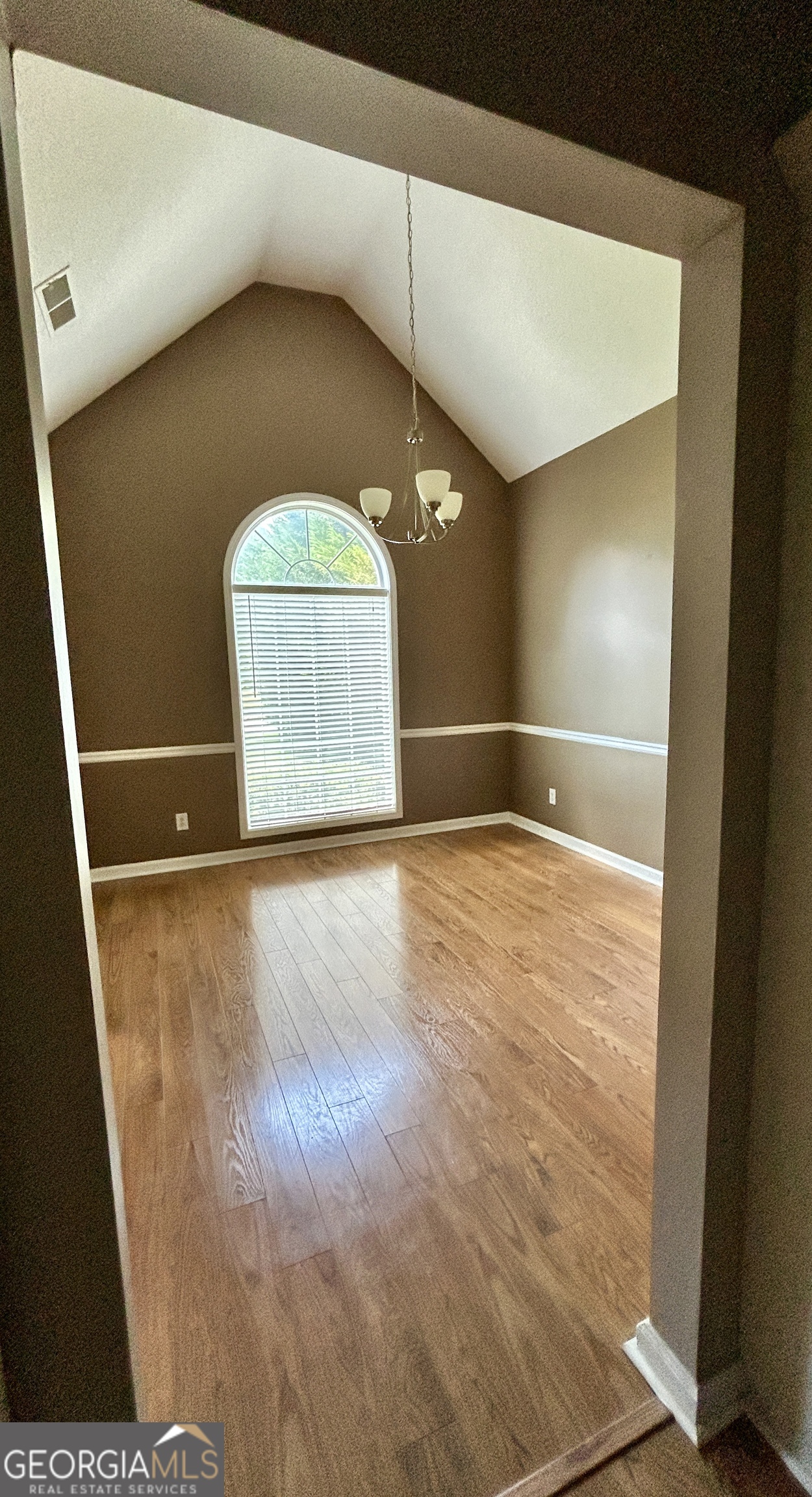 98 Pheasant Ridge Newnan, GA 30265 - Photo 3 of 23 a view of a room with a wooden floor and windows