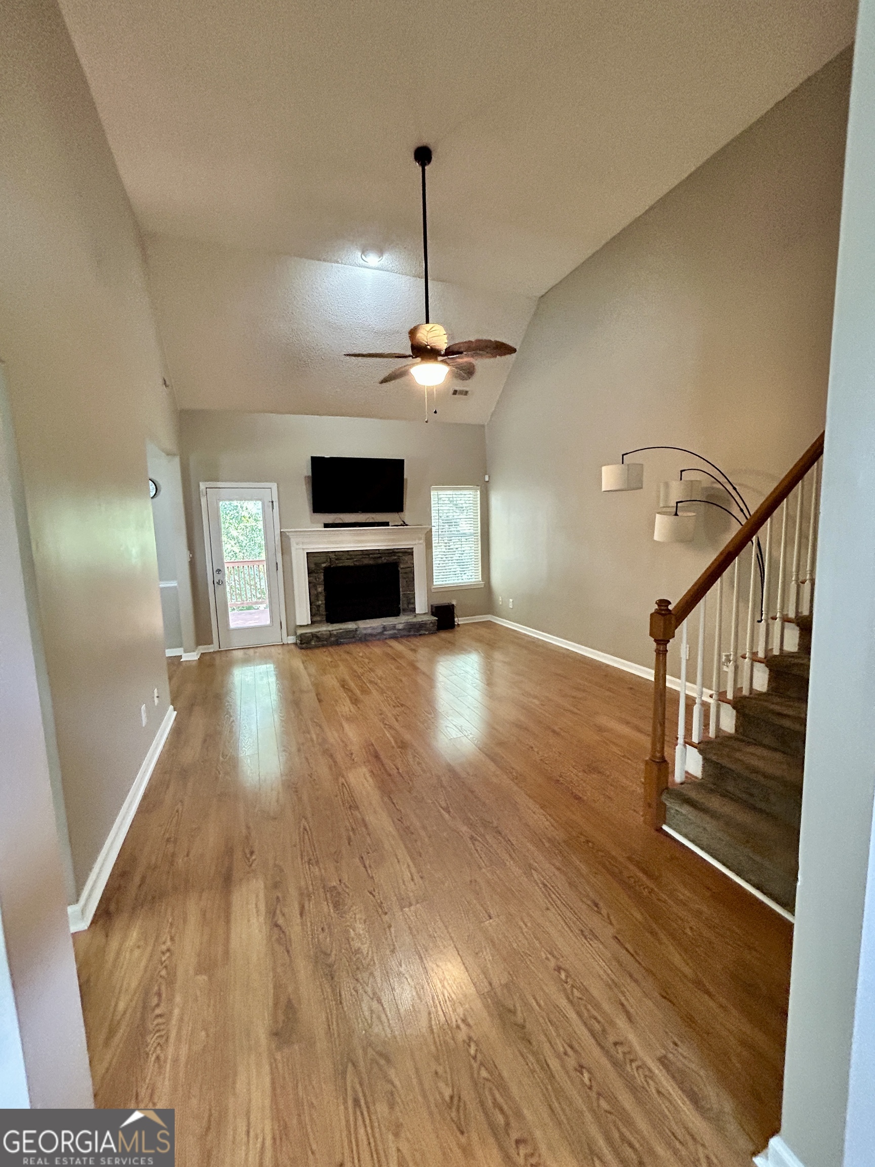 98 Pheasant Ridge Newnan, GA 30265 - Photo 4 of 23 a view of a livingroom with wooden floor and a ceiling fan