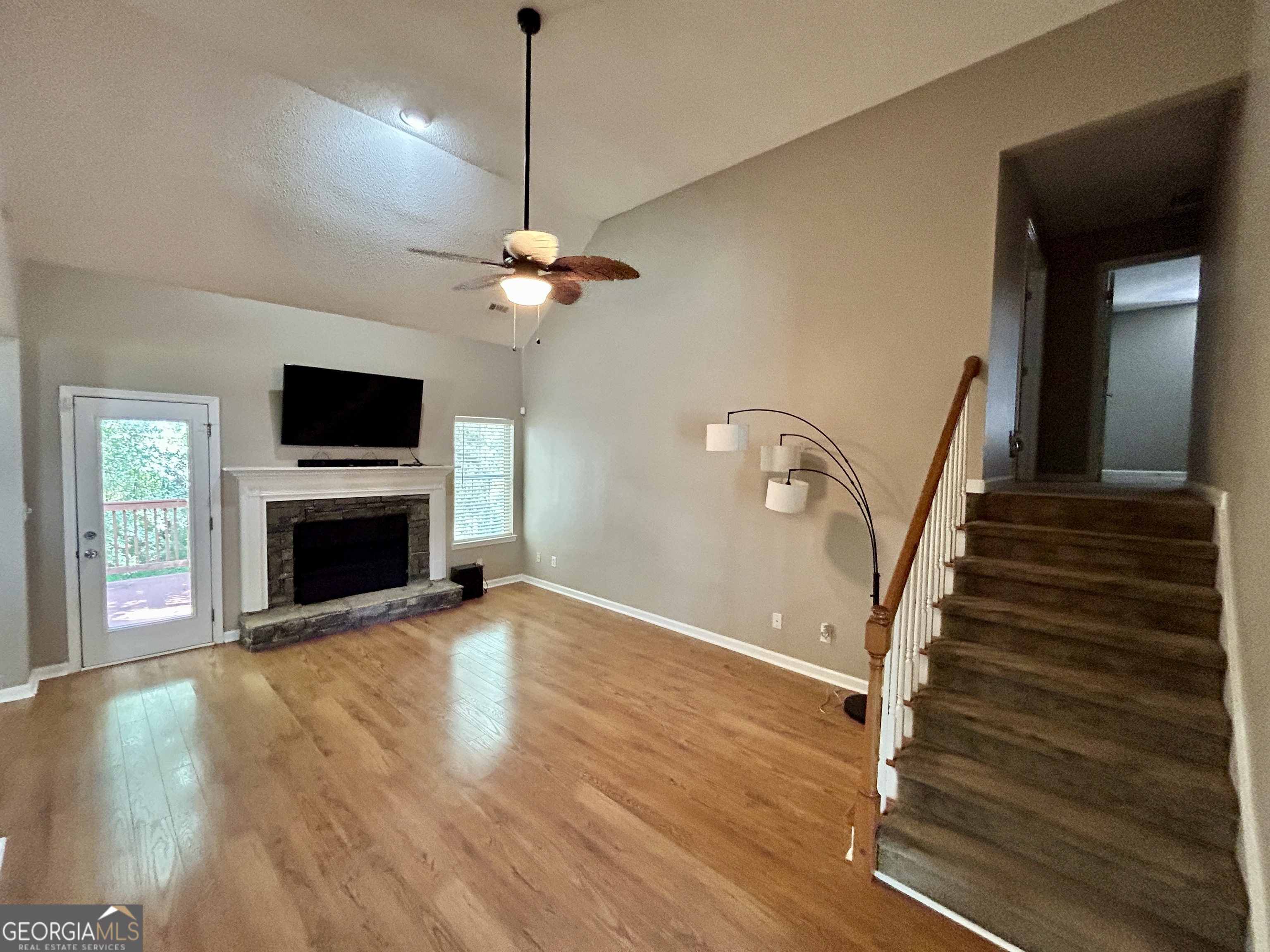 98 Pheasant Ridge Newnan, GA 30265 - Photo 5 of 23 a view of an empty room with wooden floor fireplace and a window