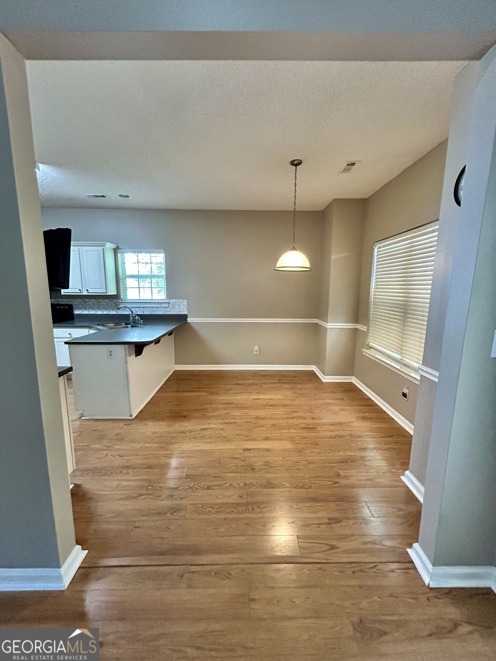 98 Pheasant Ridge Newnan, GA 30265 - Photo 6 of 23 a view of a kitchen with wooden floor and a fireplace