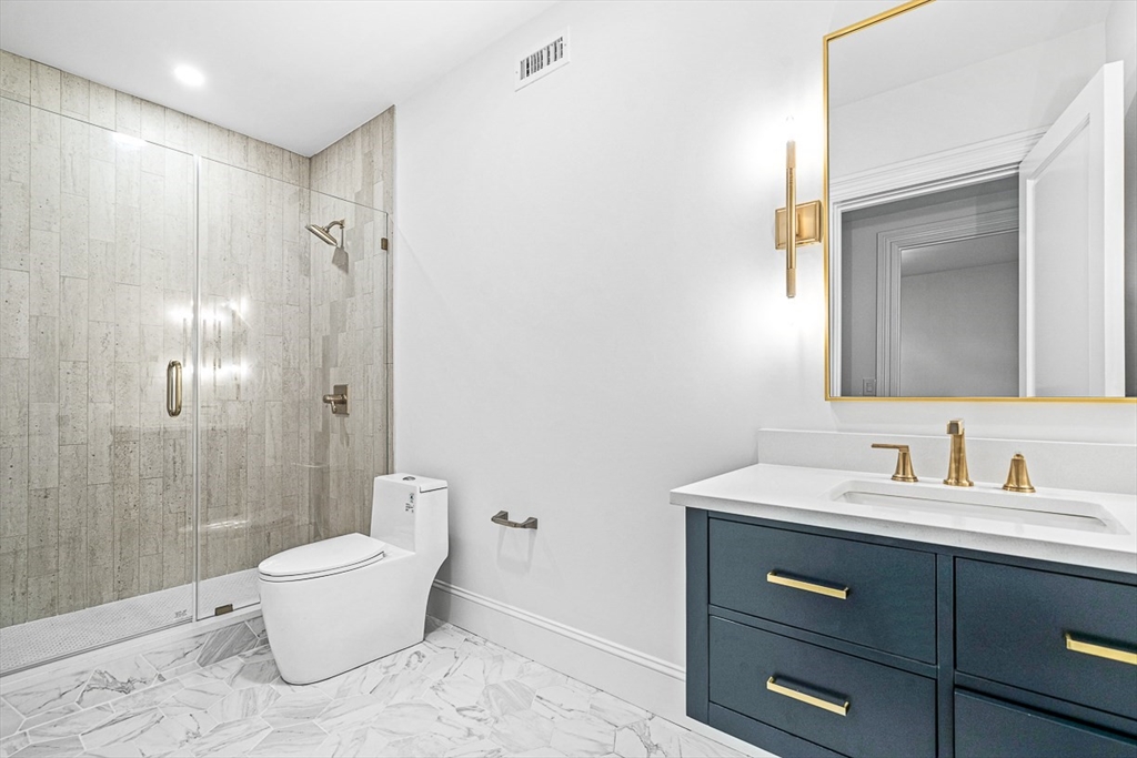 68 Parker Road Wellesley, MA 02482 - Photo 33 of 38 a bathroom with a double vanity sink toilet and shower