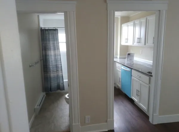 a view of hallway with sink and wooden floor