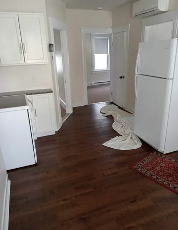 a view of kitchen and wooden floor
