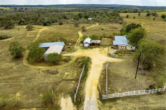 an aerial view of residential houses with outdoor space