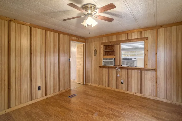 a view of an empty room with a cabinet