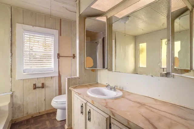 a view of an empty room with window and cabinet