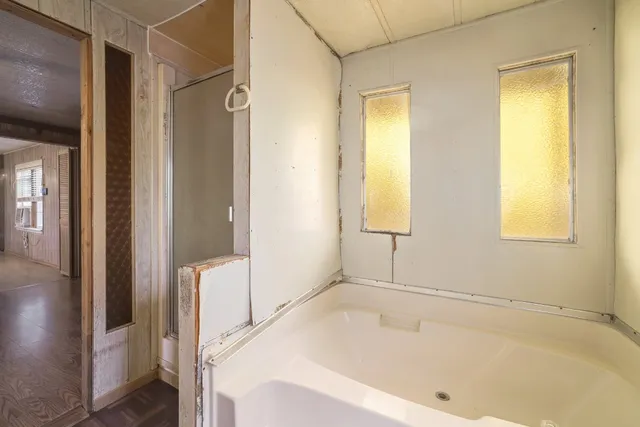 a bathroom with a sink toilet vanity and shower