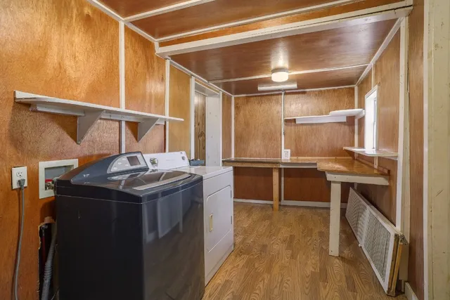 a backyard of a house with barbeque oven table and chairs