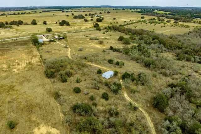 a view of a house with backyard and deck