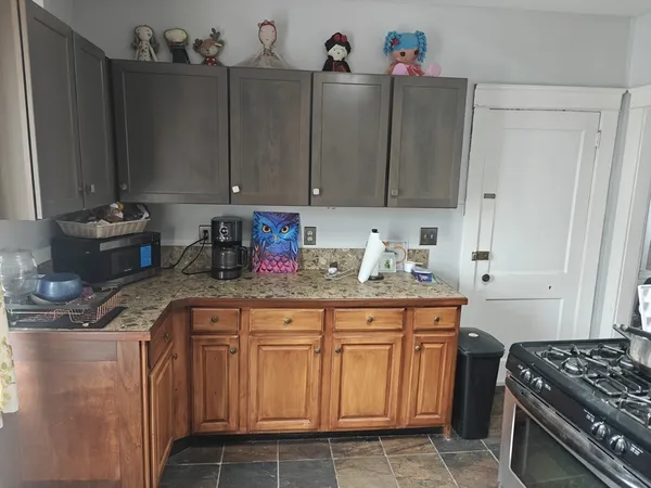 a kitchen with stainless steel appliances granite countertop a sink stove and cabinets