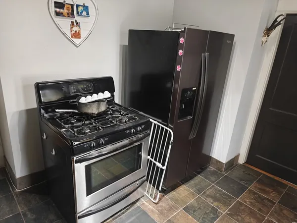 a stove top oven sitting inside of a kitchen