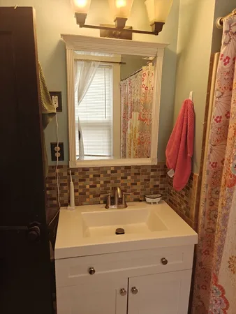 a bathroom with a sink and a mirror