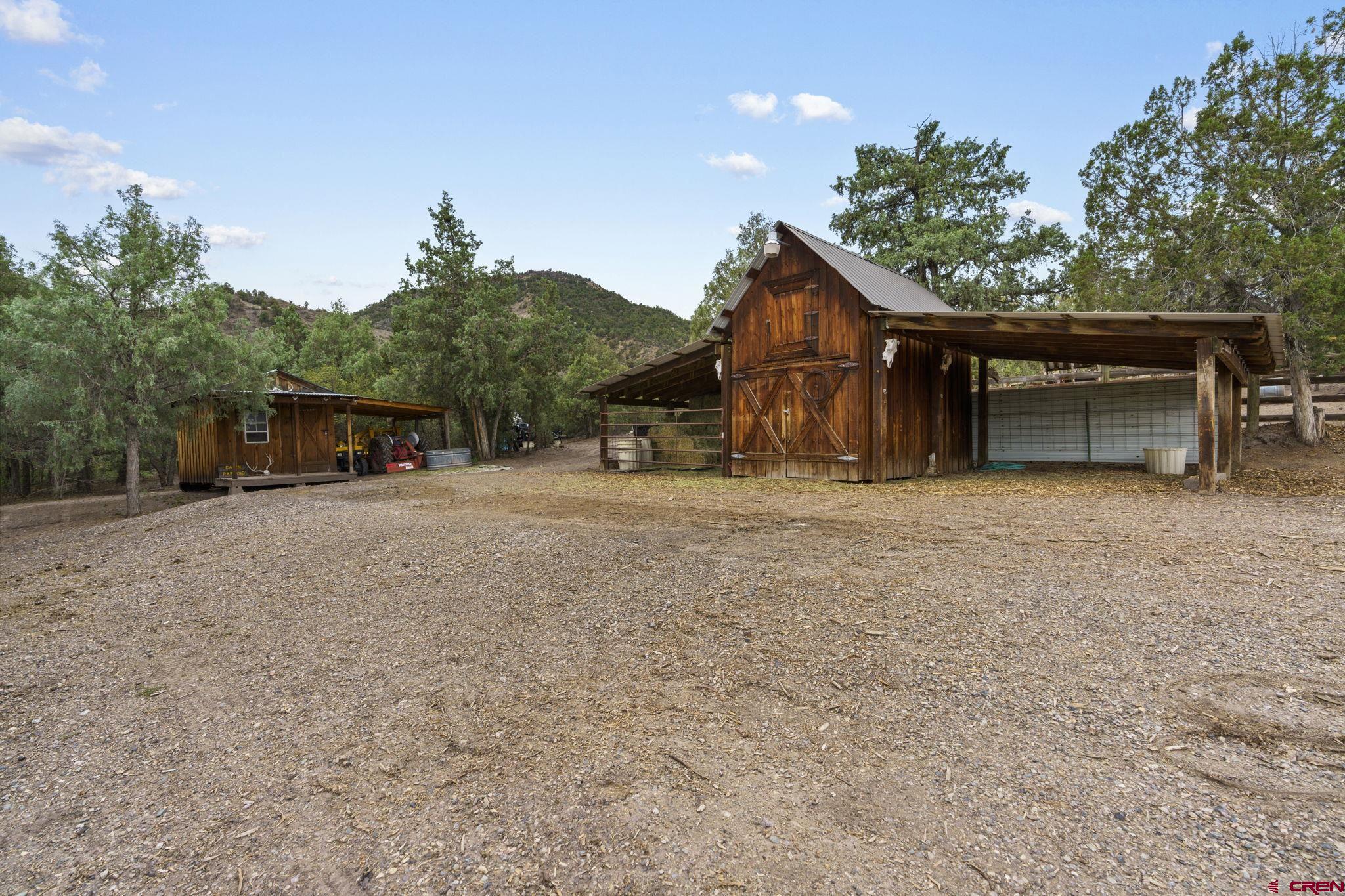 2173-2113 Rancho Durango Road Durango, CO 81303 - Photo 3 of 18 a front view of a house with a yard and garage